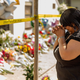 A woman weeps outside historic Mother Emanuel African Methodist Episcopal Church, June 19, 2015, in Charleston, S.C., after Dylann Roof, murdered nine people there during a prayer meeting. Now, survivors and families of the victims are asking a court to allow them to sue the federal government over what they say was a failed background check of Roof, allowing him to get the gun used in the shooting.